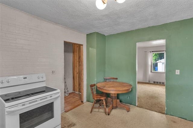 1108 Wills Ave, Lower Burrell, PA 15068 - kitchen featuring electric stove, carpet flooring, and a textured ceiling