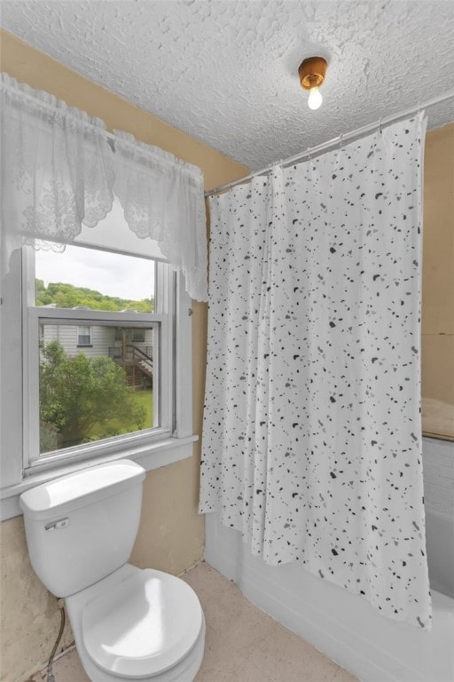 1108 Wills Ave, Lower Burrell, PA 15068 - full bath featuring toilet, a textured ceiling, tile patterned flooring, and shower / bath combo