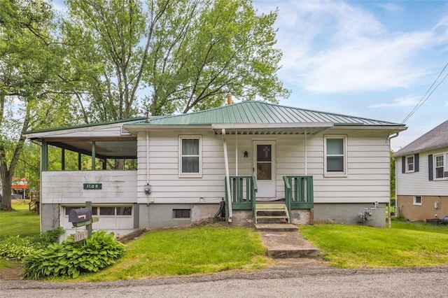 1108 Wills Ave, Lower Burrell, PA 15068 - bungalow-style house with a front lawn, metal roof, and a standing seam roof