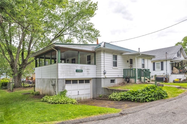 1108 Wills Ave, Lower Burrell, PA 15068 - view of front facade with an attached garage, asphalt driveway, and a front yard