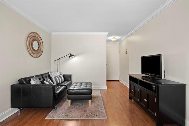 living room with ornamental molding, wood finished floors, and baseboards