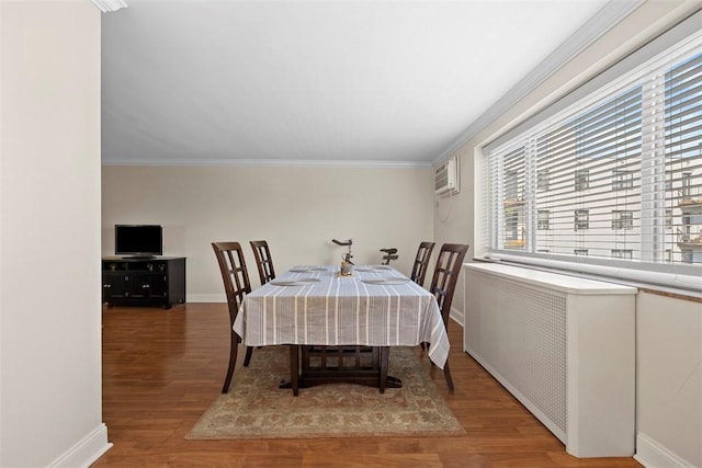 dining area with plenty of natural light, wood finished floors, crown molding, and a wall unit AC