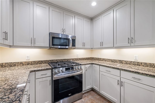 1219 Crescent Pl Unit 3C, Squirrel Hill, PA 15217 - kitchen featuring appliances with stainless steel finishes, stone counters, white cabinets, light tile patterned floors, and recessed lighting