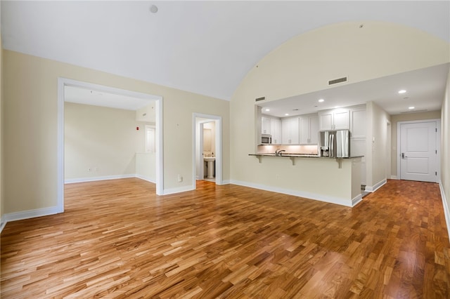 1219 Crescent Pl Unit 3C, Squirrel Hill, PA 15217 - unfurnished living room with light wood-type flooring, baseboards, vaulted ceiling, and recessed lighting