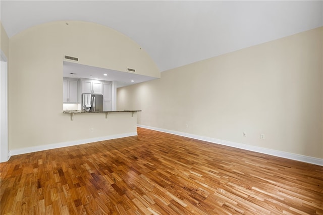 1219 Crescent Pl Unit 3C, Squirrel Hill, PA 15217 - unfurnished living room with light wood-style floors, lofted ceiling, and baseboards