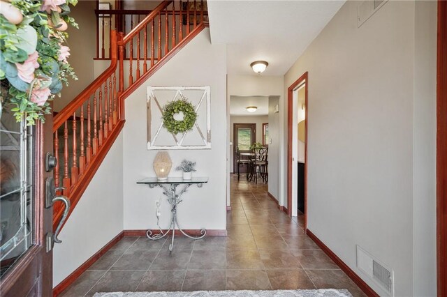 120 Rolling Mills Dr, Middlesex Twp, PA 16059 - entrance foyer with stairway, dark tile patterned flooring, and baseboards