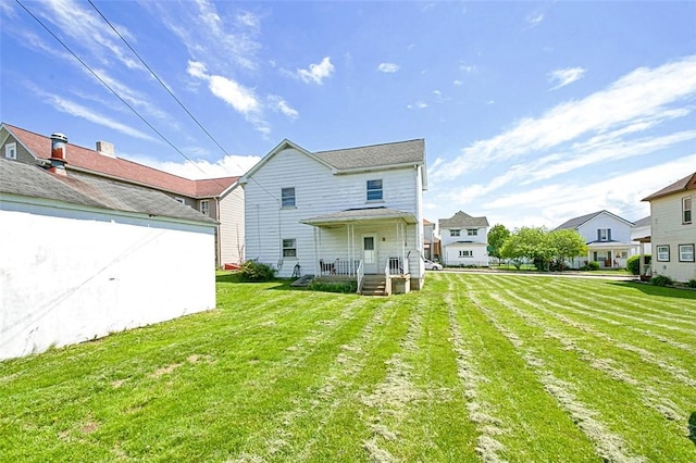 rear view of house with a lawn and a residential view