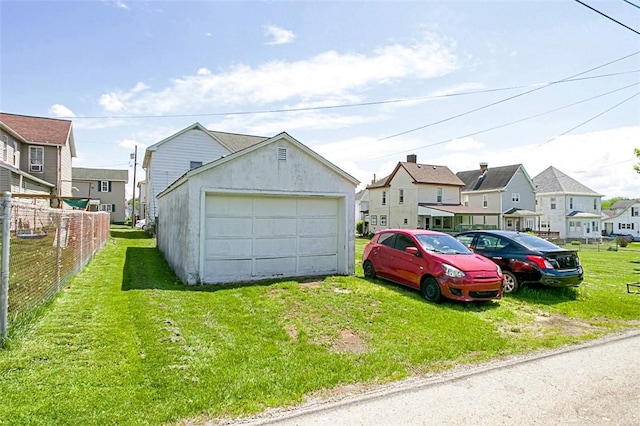 detached garage featuring a residential view