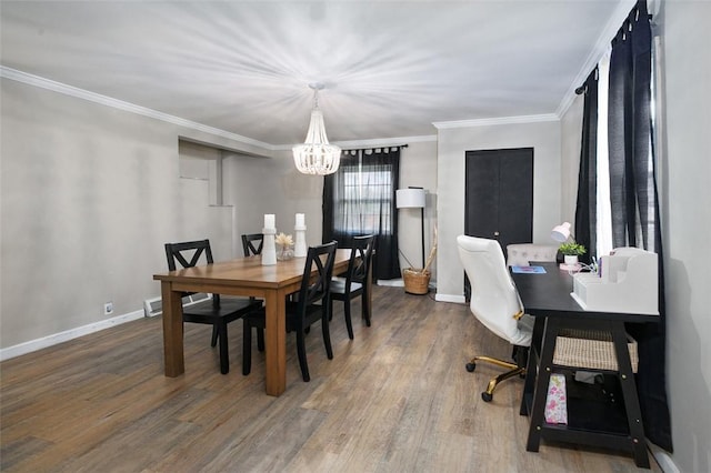 dining room with a chandelier, wood finished floors, baseboards, ornamental molding, and a desk