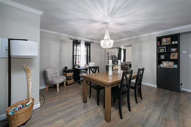 dining area with a chandelier, wood finished floors, crown molding, and baseboards