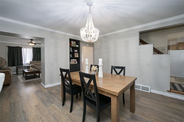 dining space featuring a chandelier, wood finished floors, crown molding, baseboards, and ceiling fan