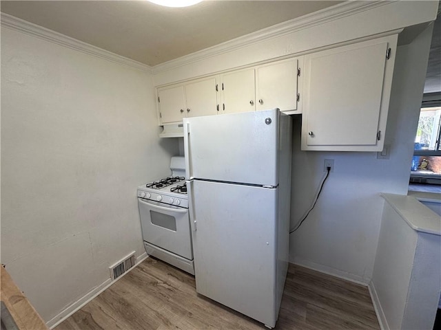 419 Elias Dr, Penn Hills, PA 15235 - kitchen featuring white appliances, wood finished floors, under cabinet range hood, ornamental molding, and white cabinets