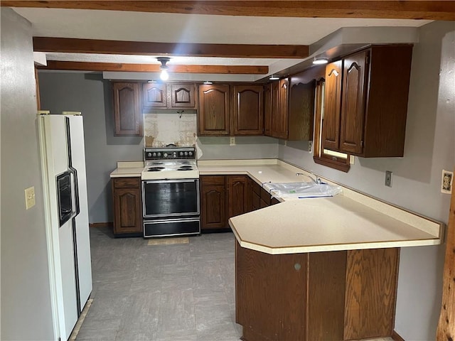 kitchen featuring range with electric stovetop, white fridge with ice dispenser, a sink, light countertops, and beamed ceiling