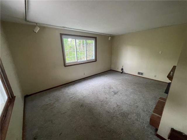 carpeted spare room with baseboards