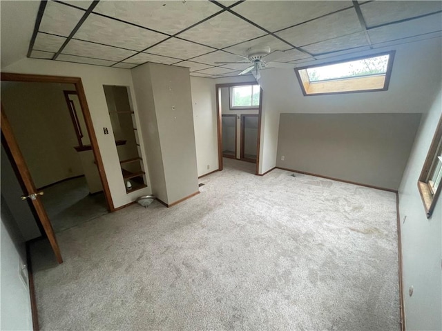 basement featuring light colored carpet and baseboards