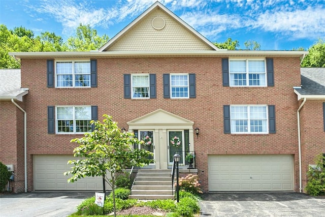 707 Cherry Blossom Ct, Murrysville, PA 15626 - view of front of property featuring an attached garage, asphalt driveway, and brick siding