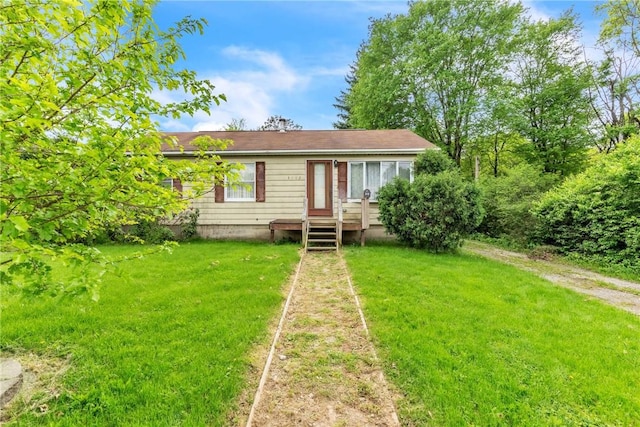 rear view of house featuring a lawn