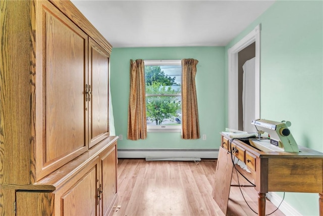 doorway to outside featuring baseboard heating and light wood-type flooring