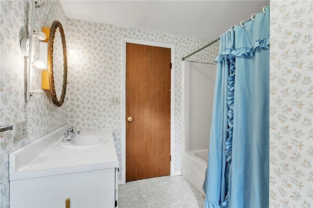bathroom featuring tile patterned flooring, vanity, shower / bath combo with shower curtain, and wallpapered walls
