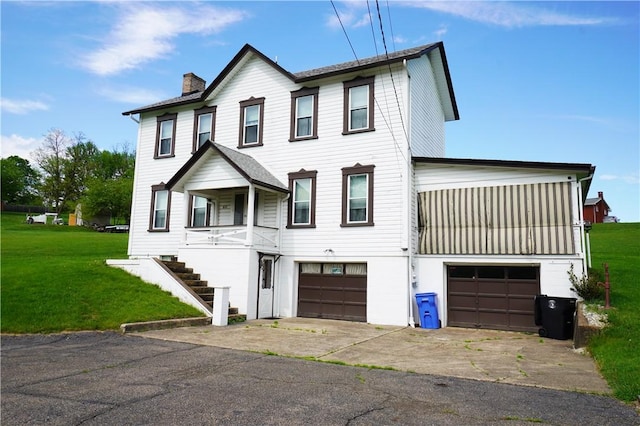 view of front of house with an attached garage, a chimney, concrete driveway, a front lawn, and stairway