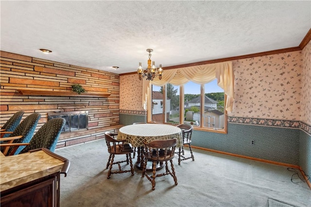 dining space with wallpapered walls, carpet flooring, ornamental molding, a chandelier, and a textured ceiling
