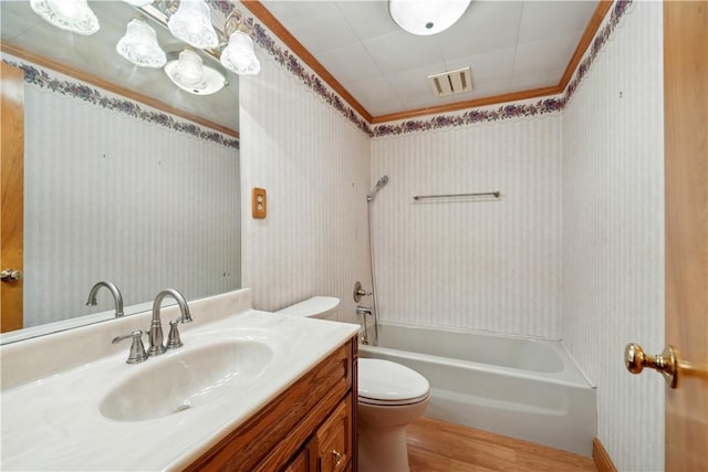 full bath featuring wood finished floors, toilet, shower / bathtub combination, vanity, and wallpapered walls