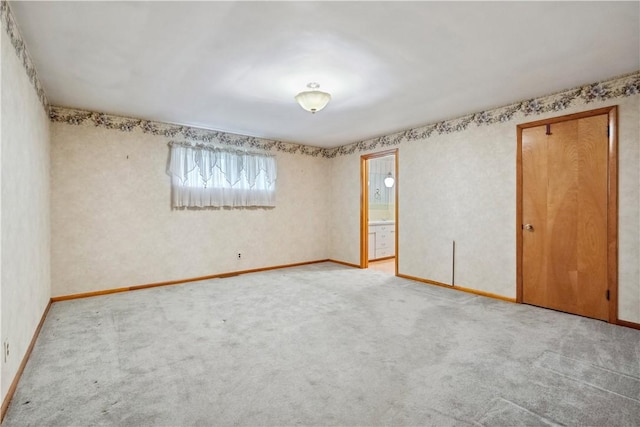 spare room with carpet floors and baseboards