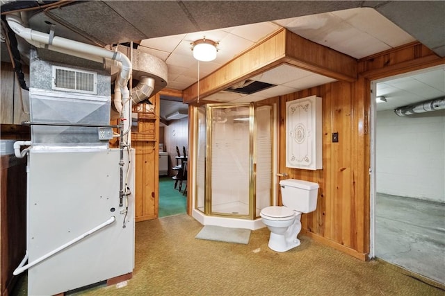unfinished below grade area featuring carpet floors, heating unit, and wooden walls