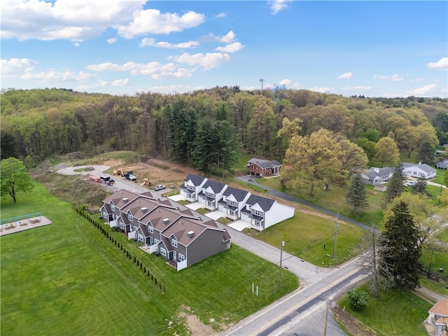 aerial view of residential area featuring a heavily wooded area