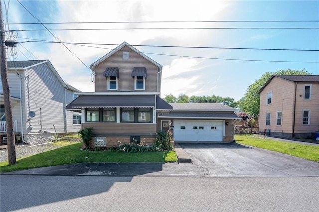 view of front of house featuring a front lawn, asphalt driveway, and an attached garage