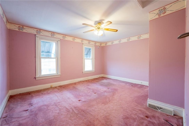 carpeted empty room featuring baseboards and ceiling fan