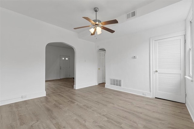 2633 S 18th St, Mount Oliver, PA 15210 - empty room featuring arched walkways, a ceiling fan, baseboards, and light wood-style flooring