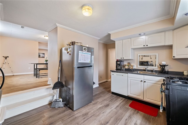 2841 Mary St, South Side, PA 15203 - kitchen featuring freestanding refrigerator, dishwasher, a sink, black range with gas stovetop, and ornamental molding
