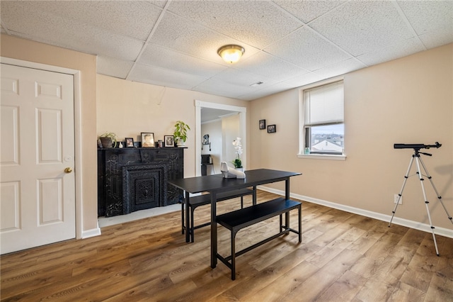 2841 Mary St, South Side, PA 15203 - dining area with a paneled ceiling, wood finished floors, baseboards, and a fireplace