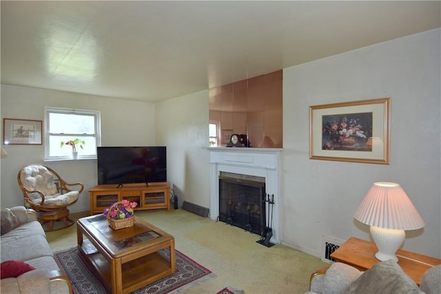 carpeted living area with a fireplace