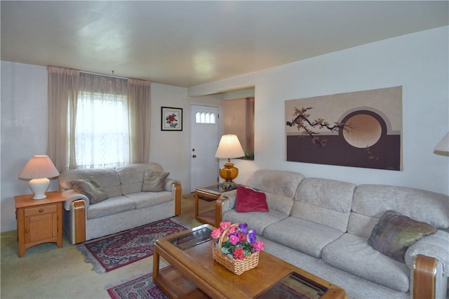living area featuring light carpet