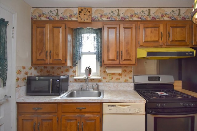 kitchen featuring gas stove, black microwave, dishwasher, light countertops, and brown cabinets