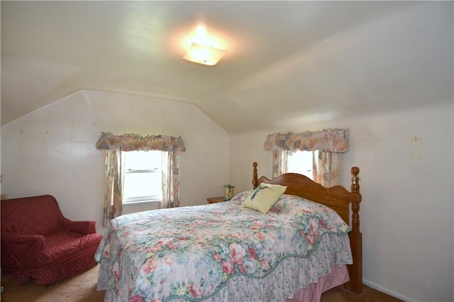 carpeted bedroom featuring lofted ceiling