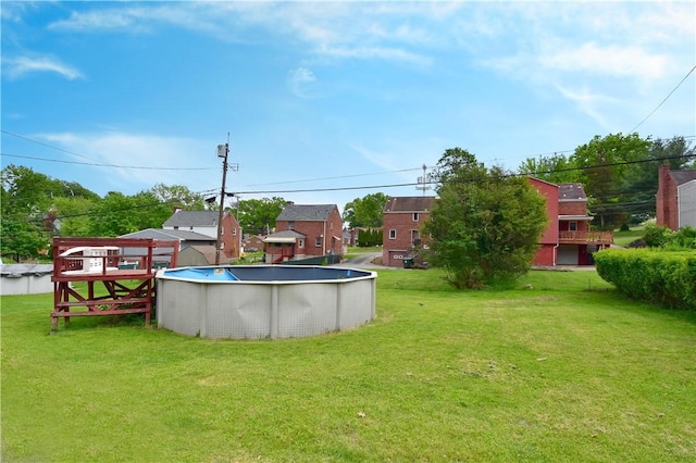 view of grassy yard with an outdoor pool