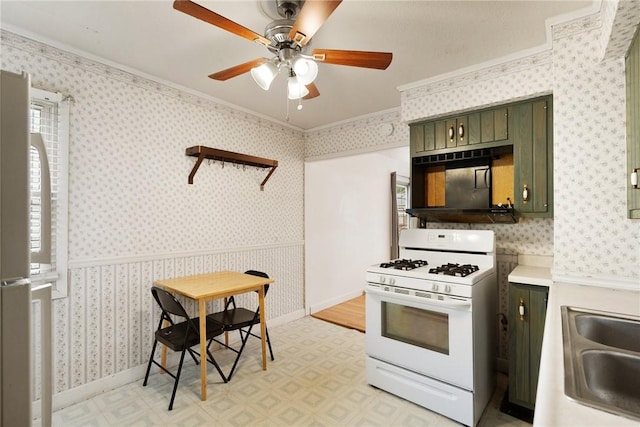 1024 Maine Ave, Hopewell Twp Bea, PA 15001 - kitchen featuring white gas range oven, green cabinetry, crown molding, light flooring, and a sink