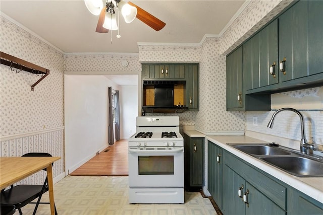 1024 Maine Ave, Hopewell Twp Bea, PA 15001 - kitchen featuring white gas range oven, green cabinets, wallpapered walls, a sink, and a ceiling fan
