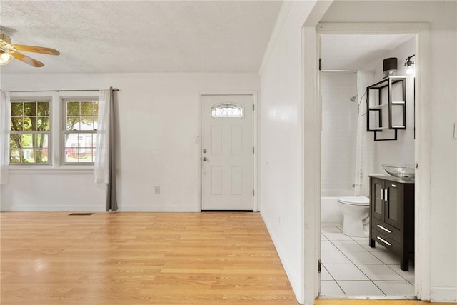 1024 Maine Ave, Hopewell Twp Bea, PA 15001 - entrance foyer with ceiling fan, healthy amount of natural light, light wood-style flooring, a textured ceiling, and baseboards