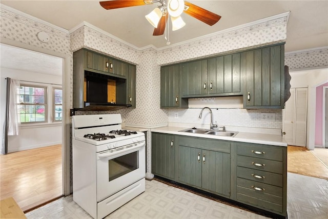 1024 Maine Ave, Hopewell Twp Bea, PA 15001 - kitchen featuring white range with gas cooktop, a sink, a ceiling fan, crown molding, and wallpapered walls