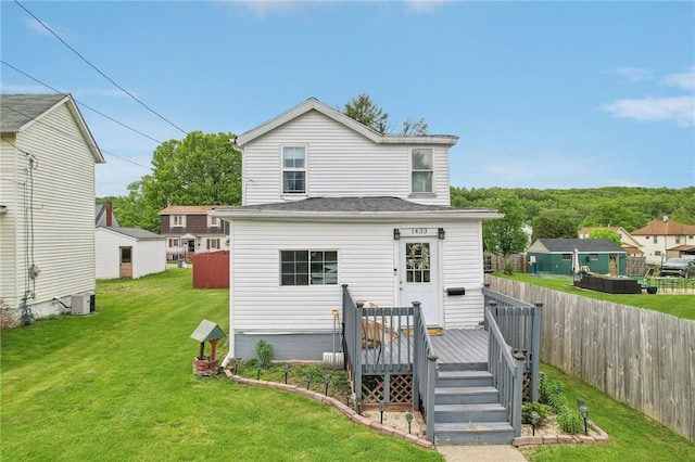 back of property with a wooden deck and central AC unit