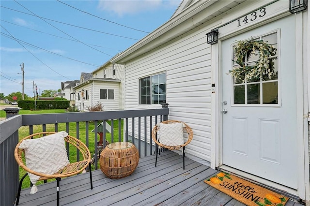 wooden terrace featuring a yard