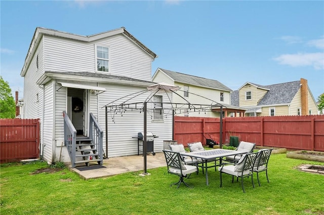 rear view of property featuring entry steps, a patio area, and a gazebo
