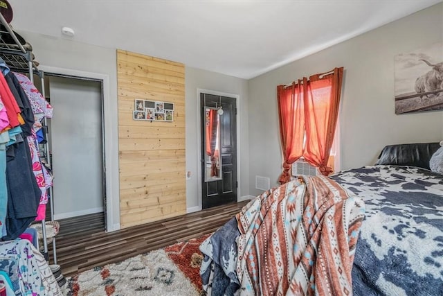 bedroom with wood finished floors and baseboards