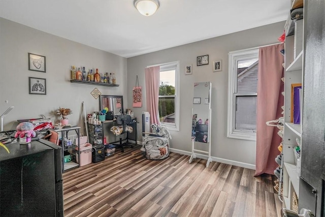 bedroom featuring wood finished floors and baseboards