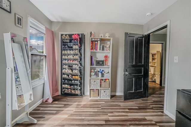 bedroom featuring wood finished floors and baseboards