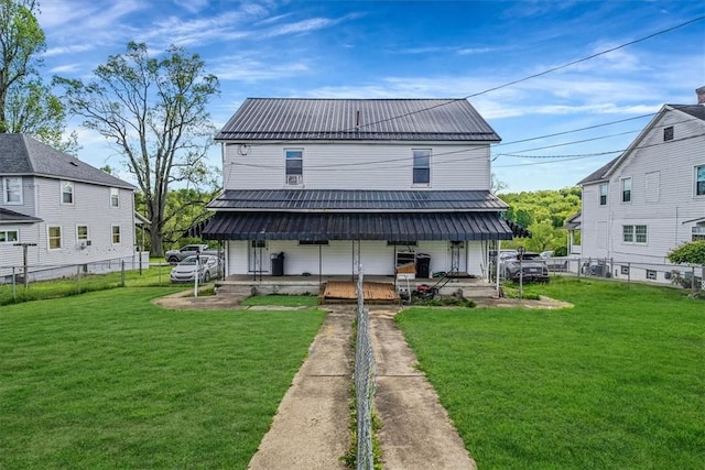 rear view of property with a porch, metal roof, and driveway
